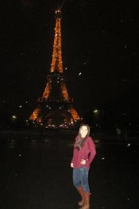 Ashley during white snowfall in Paris, France in front of the Eiffel Tower